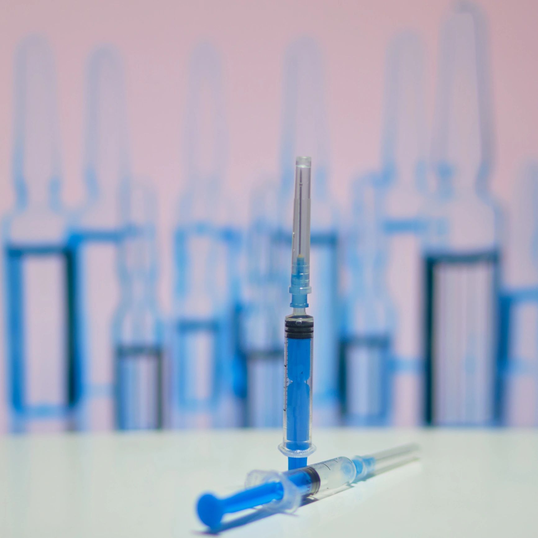 Sterile syringes on a clinical work surface (lab supplies).