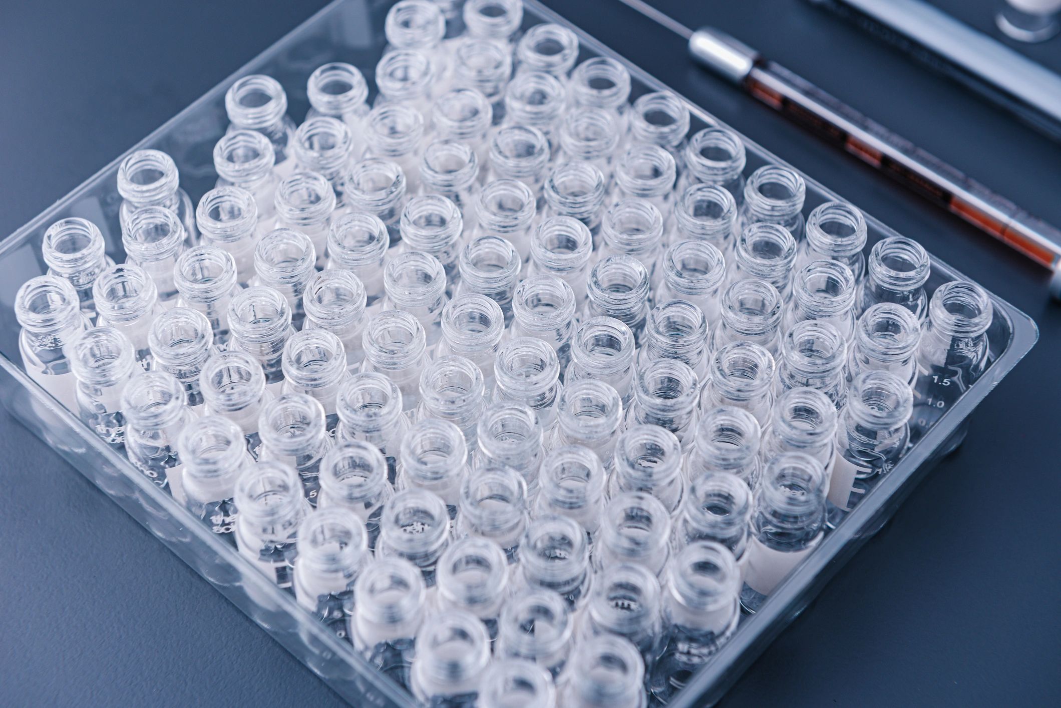 Empty glass vials arranged in a chemical laboratory.